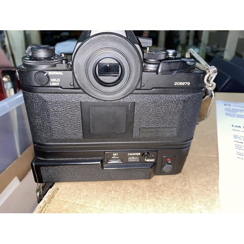 134 - A Canon F-1 SLR camera 206979 with various 
accessories and lenses, a FD 28m 1:2.8, a cannon Zoom le... 