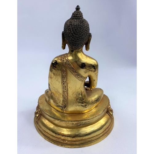 421 - A Chinese bronze gilded figure of a buddha in lotus position, ht 23cm