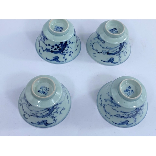425 - Four Chinese blue and white tea bowls with Prunus blossom decoration with birds, a character mark to... 