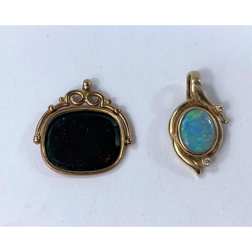 609 - A 9 carat hallmarked gold swivel fob; a yellow metal fob set with an opal coloured stone stamped '9k... 