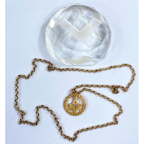 631 - A 9 carat hallmarked gold Masonic medallion on 9 carat belcher rain, 13.9 gm; a Masonic glass paperw... 