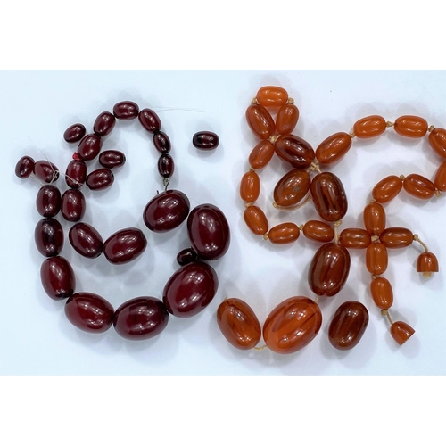 660 - A Bakelite cherry amber necklace of graduating oval beads, largest bead length 2.8 mm approx; a neck... 