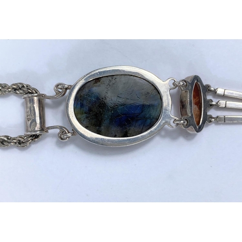 678B - A white metal pendant stamped '925' set with oval labradorite cabochon stone and lower brown agate w... 
