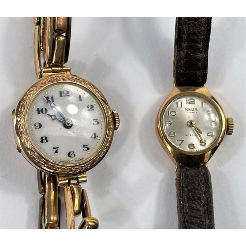696 - A ladies' 9 carat hallmarked gold wristwatch by Omega, on brown leather strap; an early 20th century... 