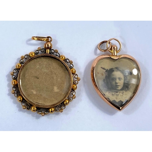 698 - A circular photo pendant in yellow metal filigree frame, stamped '15c'; another heart shaped pendant... 