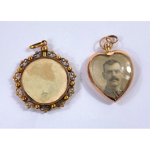 698 - A circular photo pendant in yellow metal filigree frame, stamped '15c'; another heart shaped pendant... 