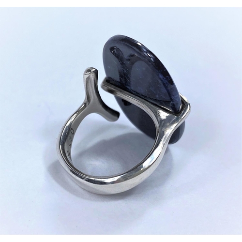 725 - Georg Jensen, an open shank silver ring with a large oval cabochon solitaire stone, held by central ... 