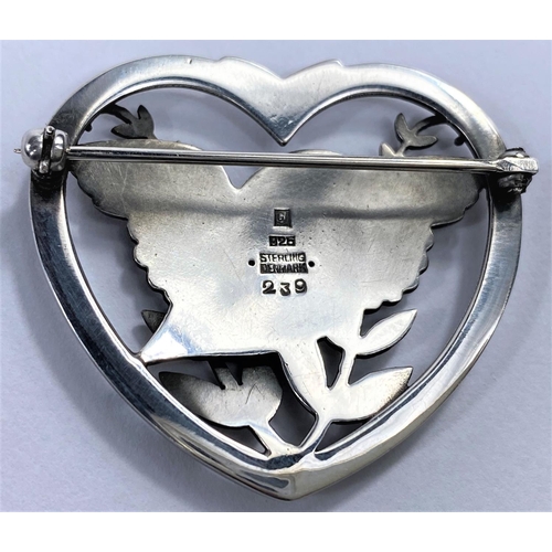 726 - Georg Jensen, a pierced heart shaped silver brooch with a bird perched in ferns, designed by Arno Ma... 