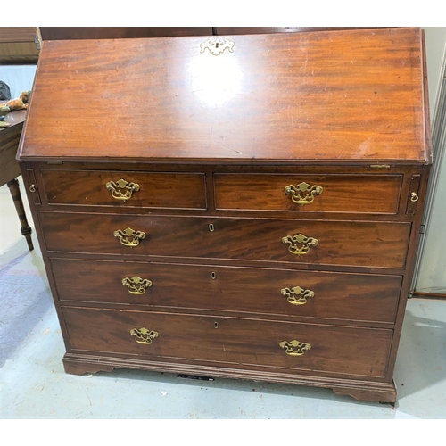 830 - A Georgian bureau bookcase with glazed double doors to the top with arched decoration, four drawers ... 