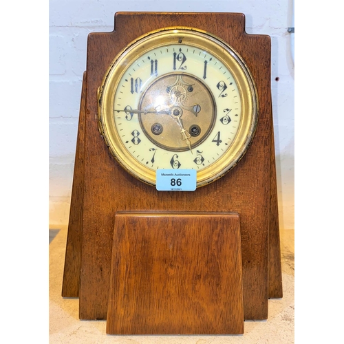 86 - An Art Deco style mahogany cased clock in an architectural design with circular dial, height 31cm (w... 