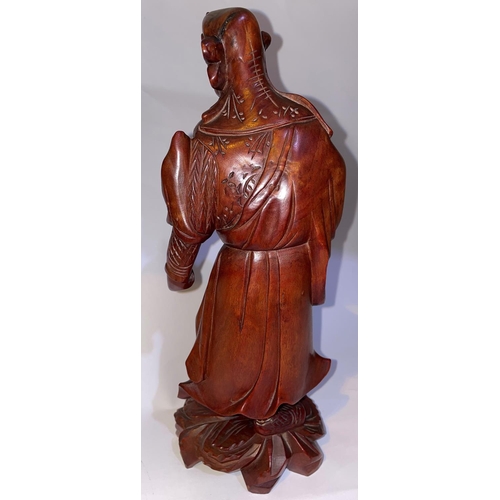 427 - A Chinese carved wooden figure of a sage with bead eyes to face and shoulder, height 30cm