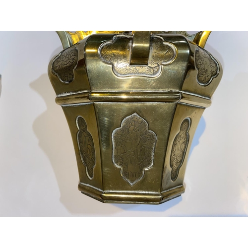 457 - A Chinese brass teapot of octagonal tapering design with engraved inset panels