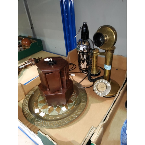 62 - A brass stick telephone; an Art Deco chrome siphon; a brass tray; a cigarette dispenser