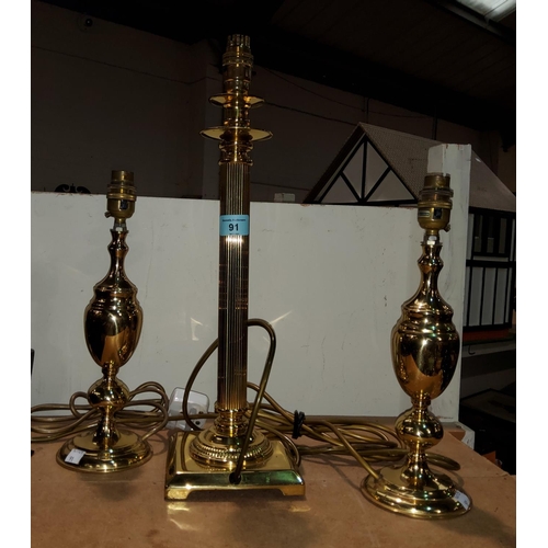 91 - A brass Corinthian column table lamp and two other table lamps