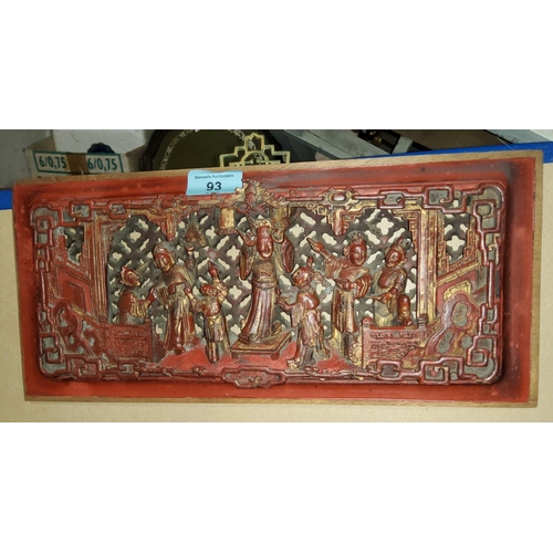 93 - A relief carved panel, part gilded and lacquered, decorated with figures surrounding a potentate