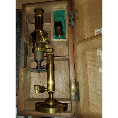 95 - A late 19th/early 20th century brass microscope, boxed
