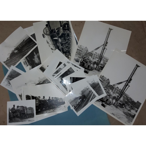 192B - A collection of old black and white photographs of various steam trains pulling carriages etc. and t... 