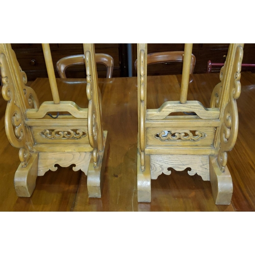 411 - A pair of Chinese carved, pierced, hardwood temple lamp stands, with dragon mounts (converted to ele... 