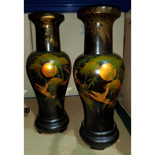 77 - A mid 1900's pair of Japanese style lacquered vases, decorated in gilt with birds in flight