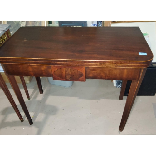 790 - A 19th century mahogany inlaid fold over tea table with
tapering legs
