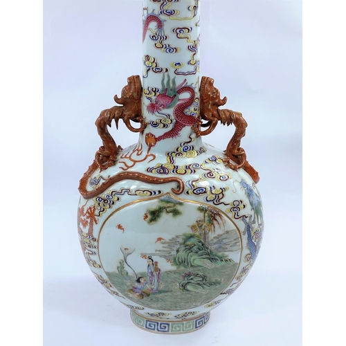 409 - A Chinese Moon flask shaped vase decorated with 
 polychrom panels of traditional scenes, surrounded... 