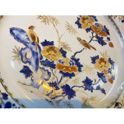 420 - A large Chinese porcelain charger with central panel depicting birds on trees with gilt highlights, ... 