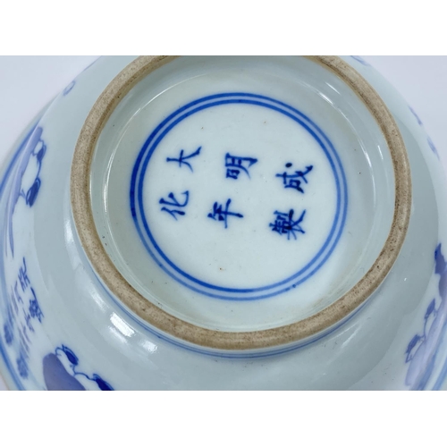 433 - A Chinese ceramic blue and white rice bowl decorated with Chinese text, sages etc, with six characte... 