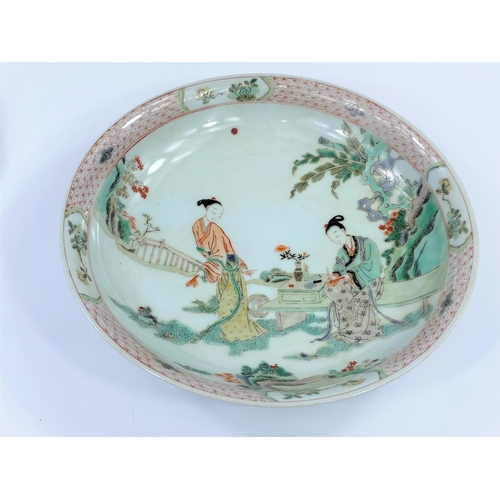446 - A Chinese famille verte dish decorated with two ladies working
on calligraphy, diameter 29.5cm
