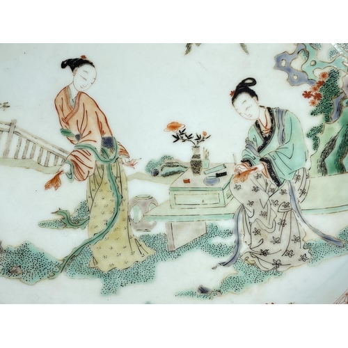 446 - A Chinese famille verte dish decorated with two ladies working
on calligraphy, diameter 29.5cm