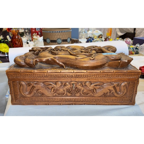 419 - A late 19th / early 20th century Chinese carved wood jewellery box with dragon in high relief