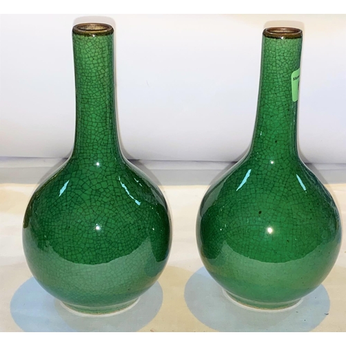426 - A pair of Chinese monochrome green crackle glaze bottle vases, with slender necks and bulbous bodies... 