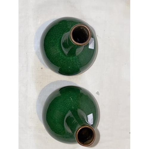 426 - A pair of Chinese monochrome green crackle glaze bottle vases, with slender necks and bulbous bodies... 
