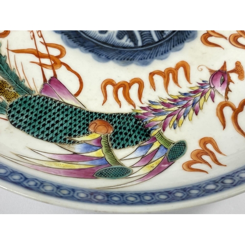 439 - A Chinese ceramic dish, decorated with dragon and mythical
bird circling the centre of the plate, wi... 