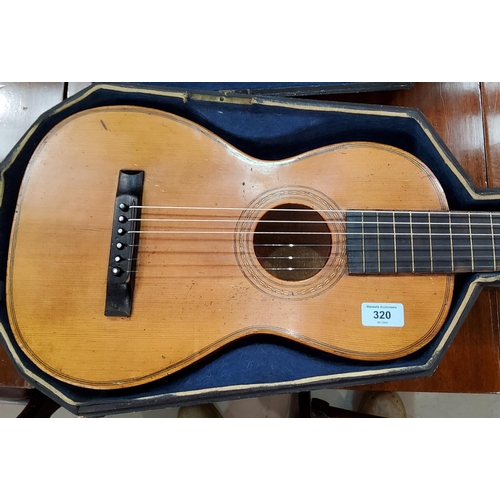 320 - A late 19th / early 20th century 6 string classical parlour guitar in original wooden case