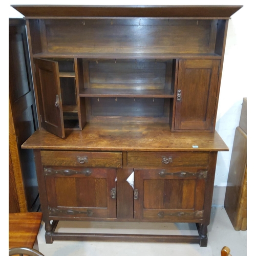 868 - An early 20th century oak dresser of Art Nouveau style with applied iron hinges and handles, 152 cm