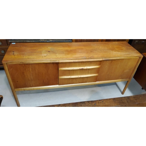 928 - A mid 20th century Mackintosh teak lowline sideboard with rounded corners, 3 slightly bow front cent... 