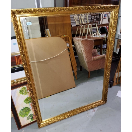 807 - A large rectangular wall mirror with bevelled edge