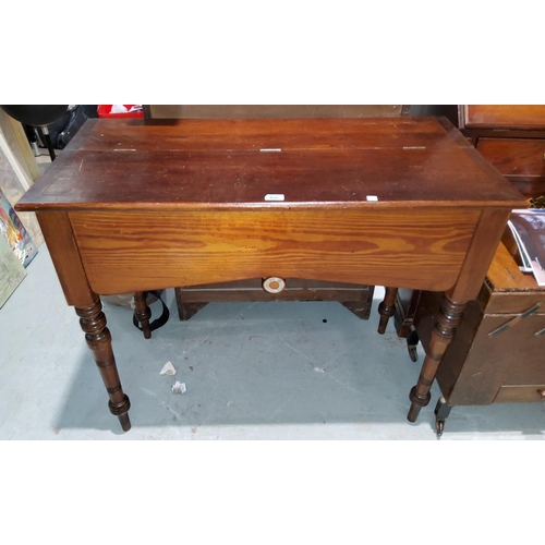 821 - A Victorian pitch pine side table/desk with half opening top, on decorative turned legs, bears label... 