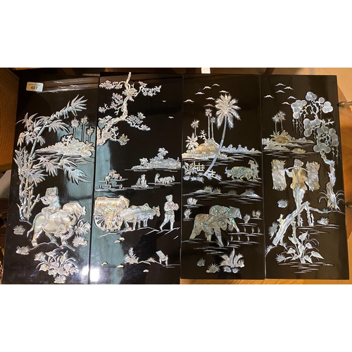 407 - A set of four Japanese lacquered panels,  with mother of pearl inlaid country scenes.