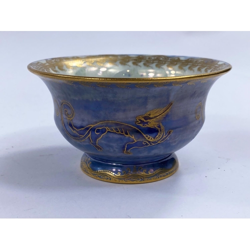 486 - A Wedgwood lustre pedestal bowl on raised foot decorated with dragons against a mottled blue ground,... 