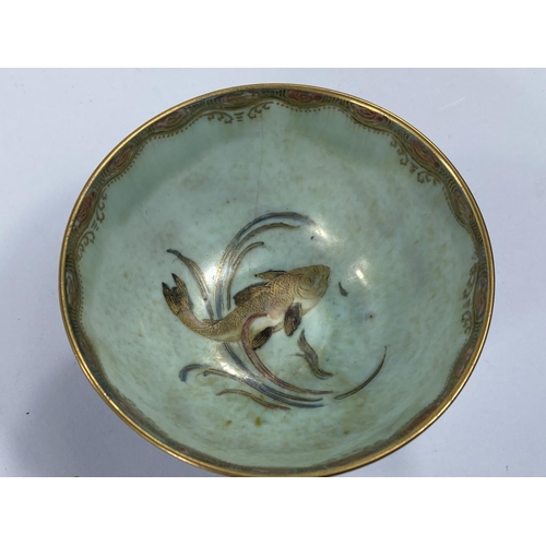 487 - A Wedgwood lustre circular bowl on raised foot decorated with fish against a mottled blue ground, Z4... 