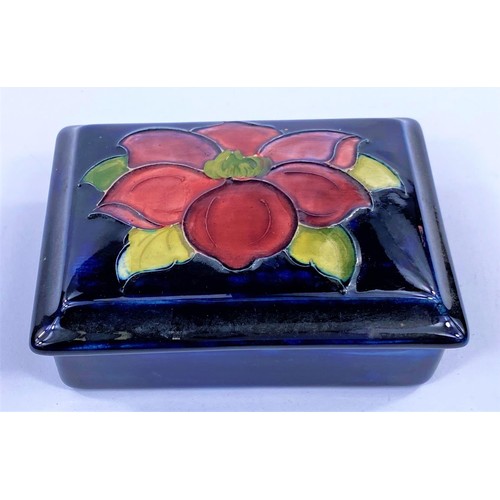 475 - A Moorcroft covered rectangular box with dark blue ground, original paper label to lid, length 12.5 ... 