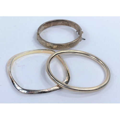 632C - A hallmarked silver bangle, another hallmarked silver bangle and another