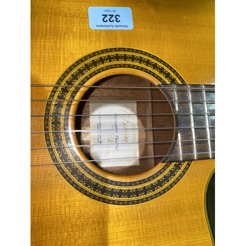 322 - A cut away classical guitar by Takamine, with hard carry case - The electrics will require some atte... 