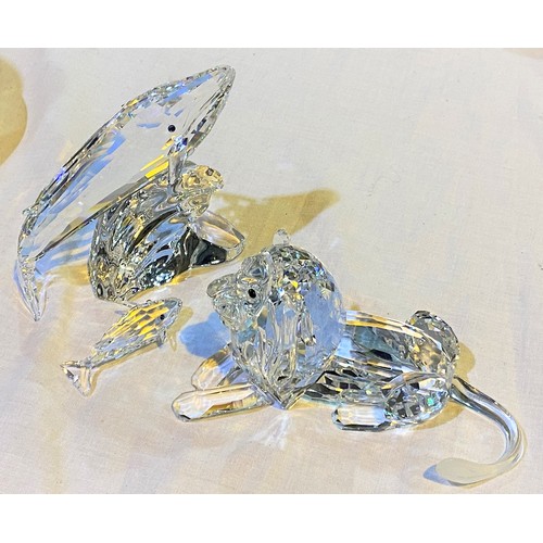 594 - A Swarovski lion (one leg unglued); a mother and baby Swarovski whales (all present but 2 joints ung... 