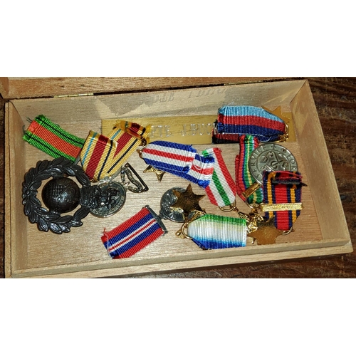 45 - A group of miniature medals and badges.