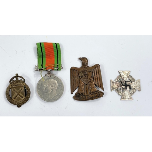 52c - A WWII Defense medal, a War Munition Volunteer badge and 2 other items
