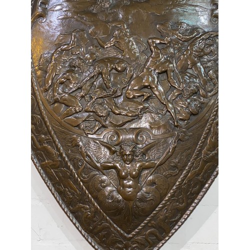 50 - A late 19th/early 20th century unusual bronzed shield decorated in relief with classical scene:  Zeu... 