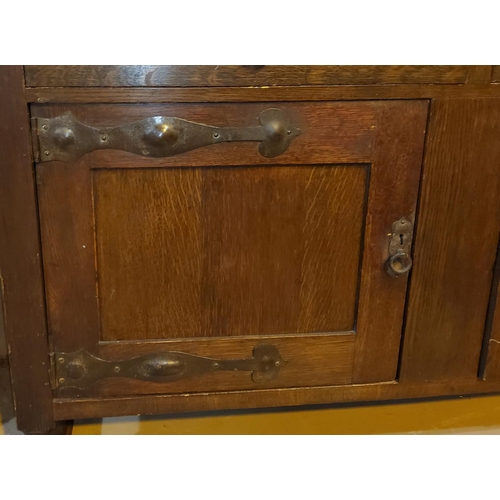 834 - An early 20th century oak dresser of Art Nouveau style with applied iron hinges and handles 152cm