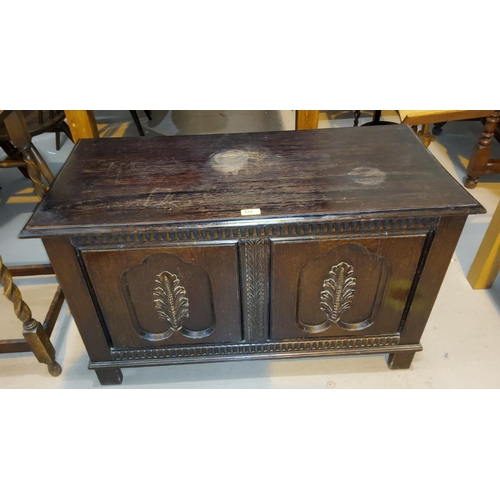 907 - A 1930's carved oak bedding box, a barley twist tea trolley and a nest of 3 oak occasional tables